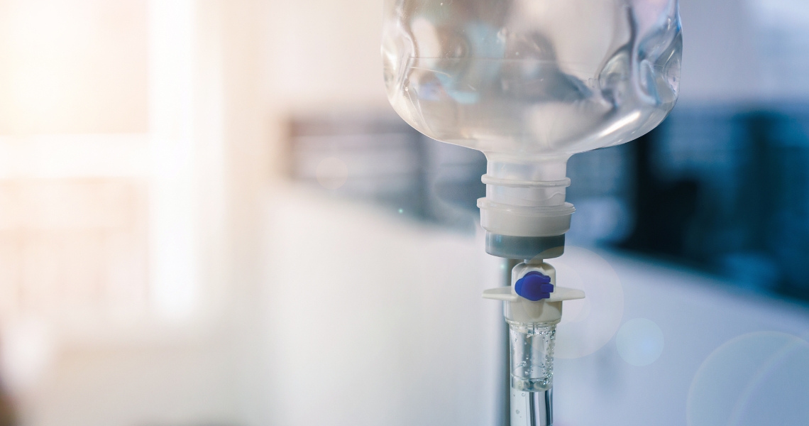 An IV bag with a blue and white toned background.