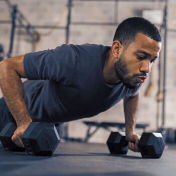 A man doing pushups using weights.