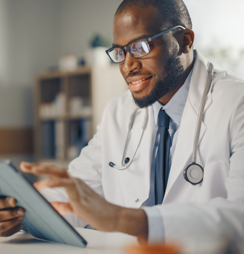 Doctor at desk with an ipad