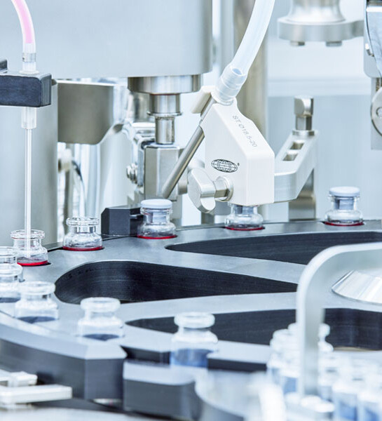 Machinery filling vials.