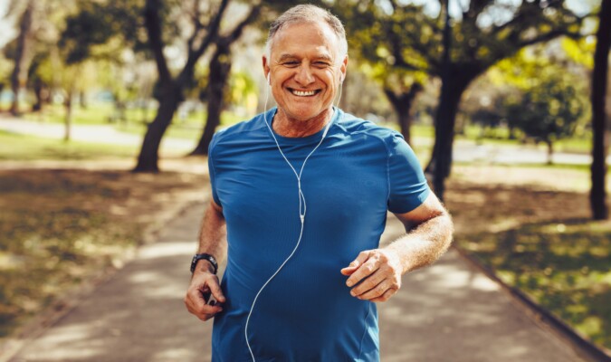 Man in blue shirt jogging outside.