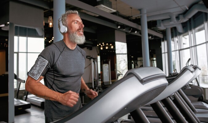 An older man running on a treadmill.