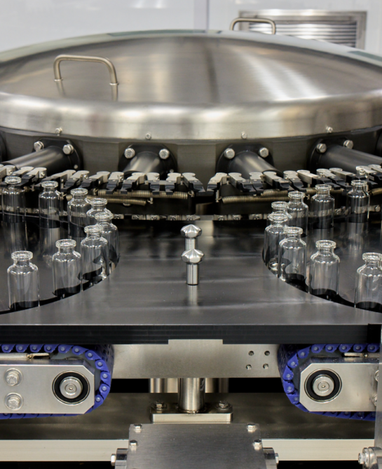 Empty vials going into a machine