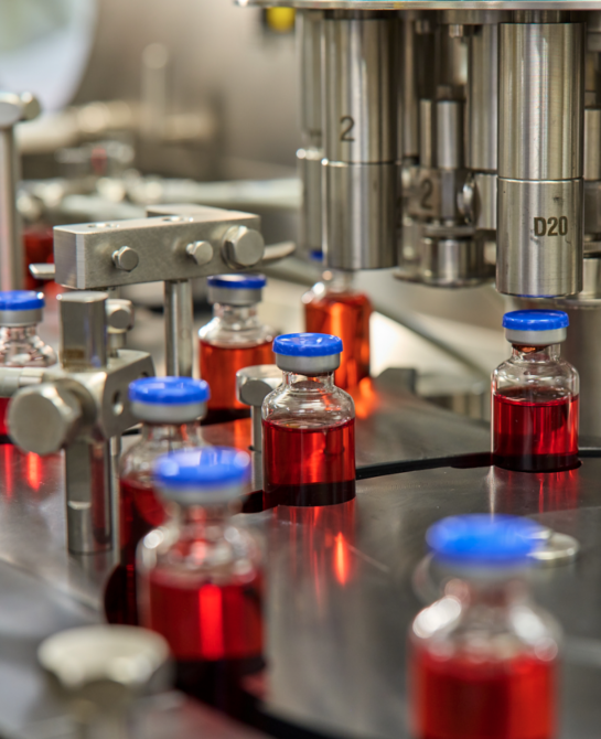 Vials of liquid going through a machine