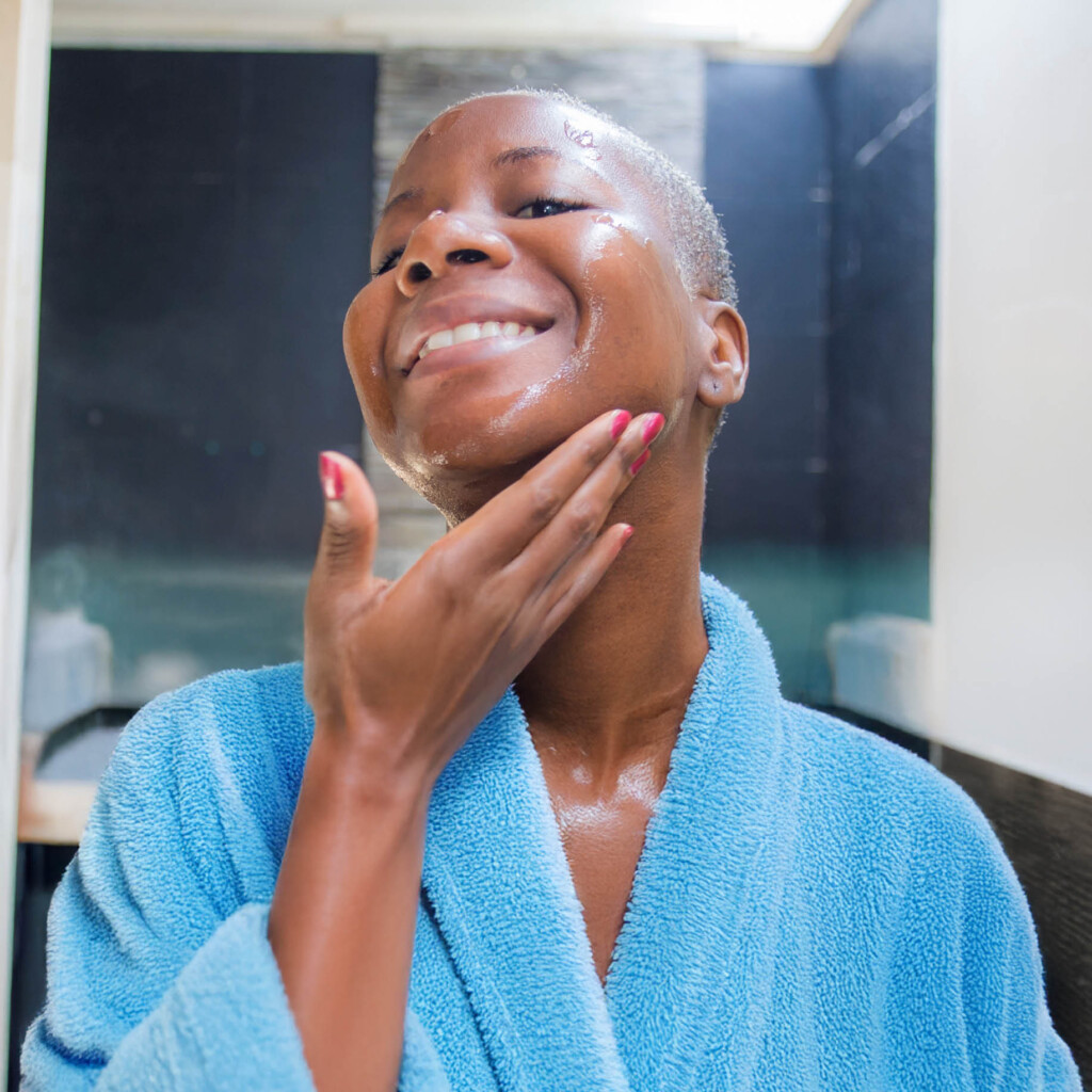 empower-pharmacy-dermatology-600×600-2025-2 female in bathroom putting cream on