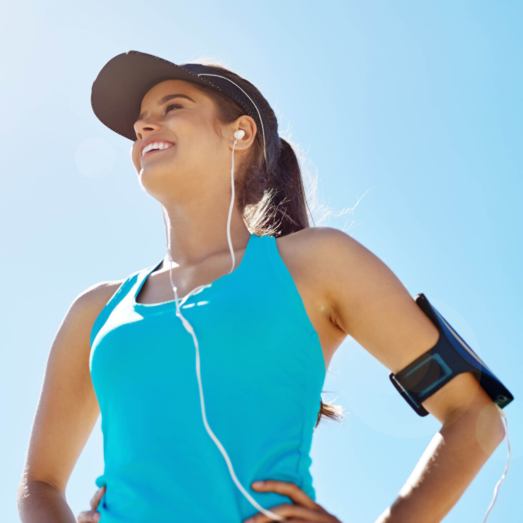 empower-pharmacy-womens-health-600×600-2025 woman exercising outside wearing hat and listening to music
