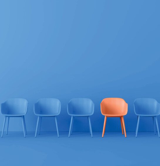 set of 5 chairs, 4 are blue, 1 is orange to stand out