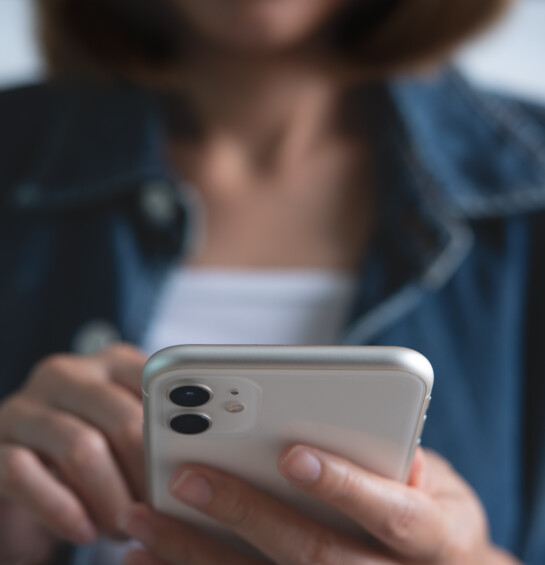 Close up of young asian woman hands holding and using mobile smart phone for online shopping and internet banking via mobile app