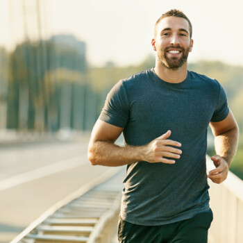 young man running and smiling