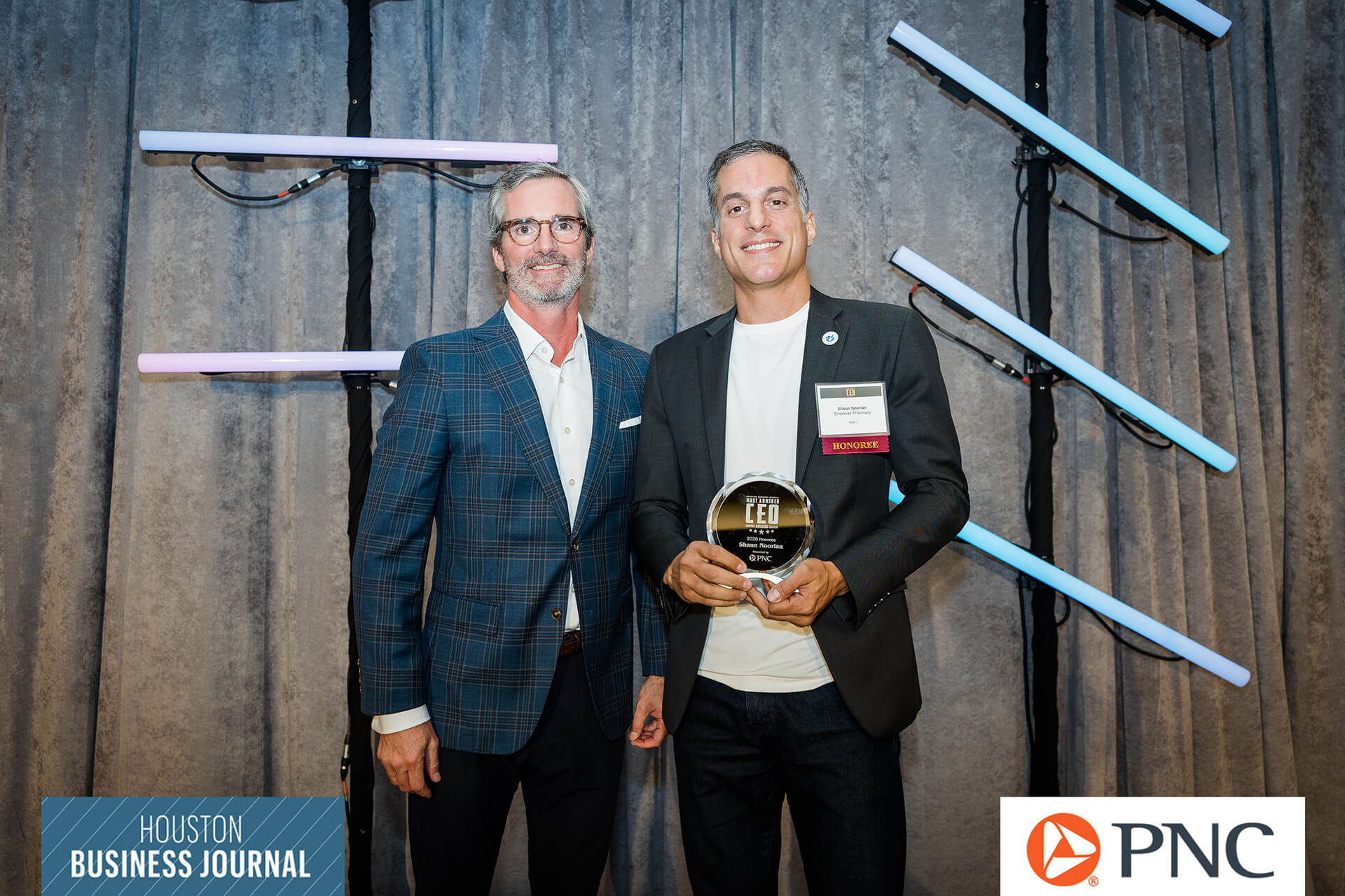 Shaun poses with an award at Houston Business Journal event.